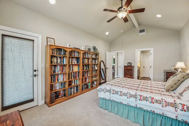 a bedroom with a large bed and a chandelier