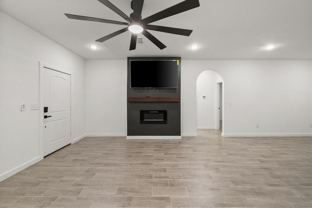 6771 Northwest County Road 1146 Barry, TX 75102 - Photo 7 of 34 wooden floor in an empty room with a fireplace