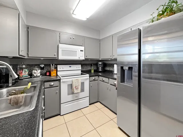 a kitchen with stainless steel appliances granite countertop a sink and cabinets