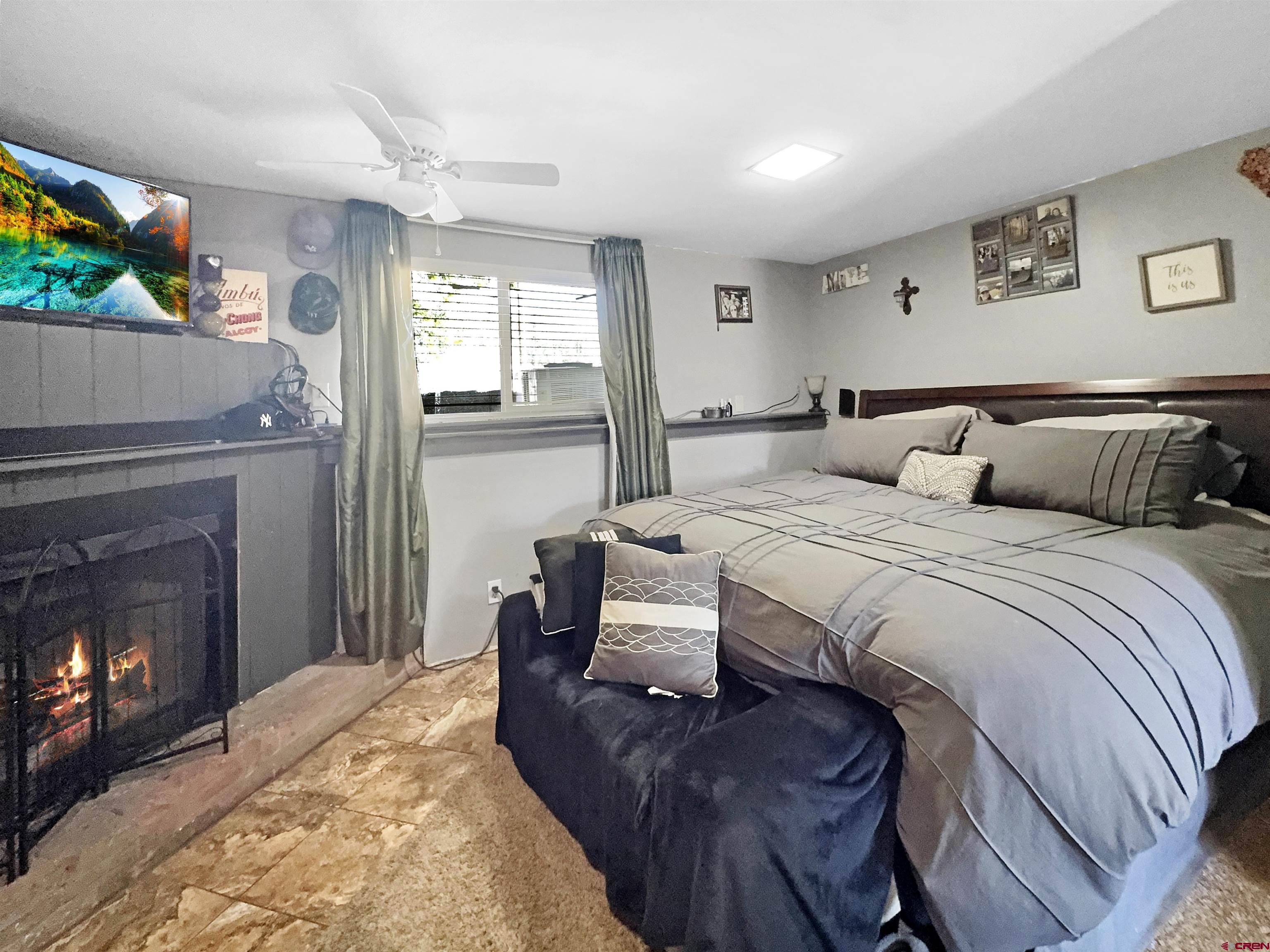 8 West 10th Street Cortez, CO 81321 - Photo 17 of 24 a bedroom with a bed and a fireplace