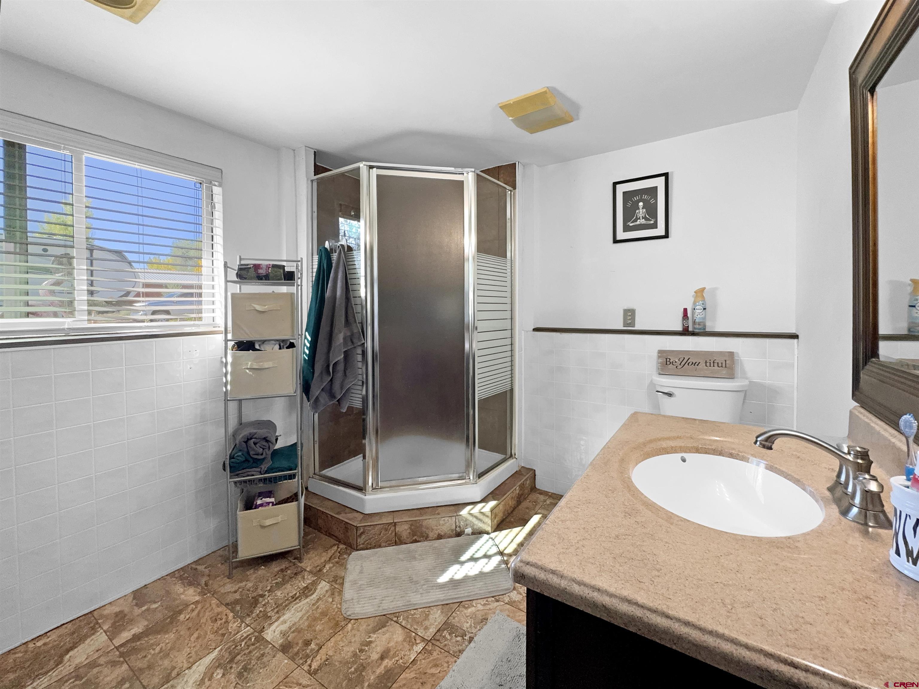 8 West 10th Street Cortez, CO 81321 - Photo 19 of 24 a bathroom with a sink toilet and shower