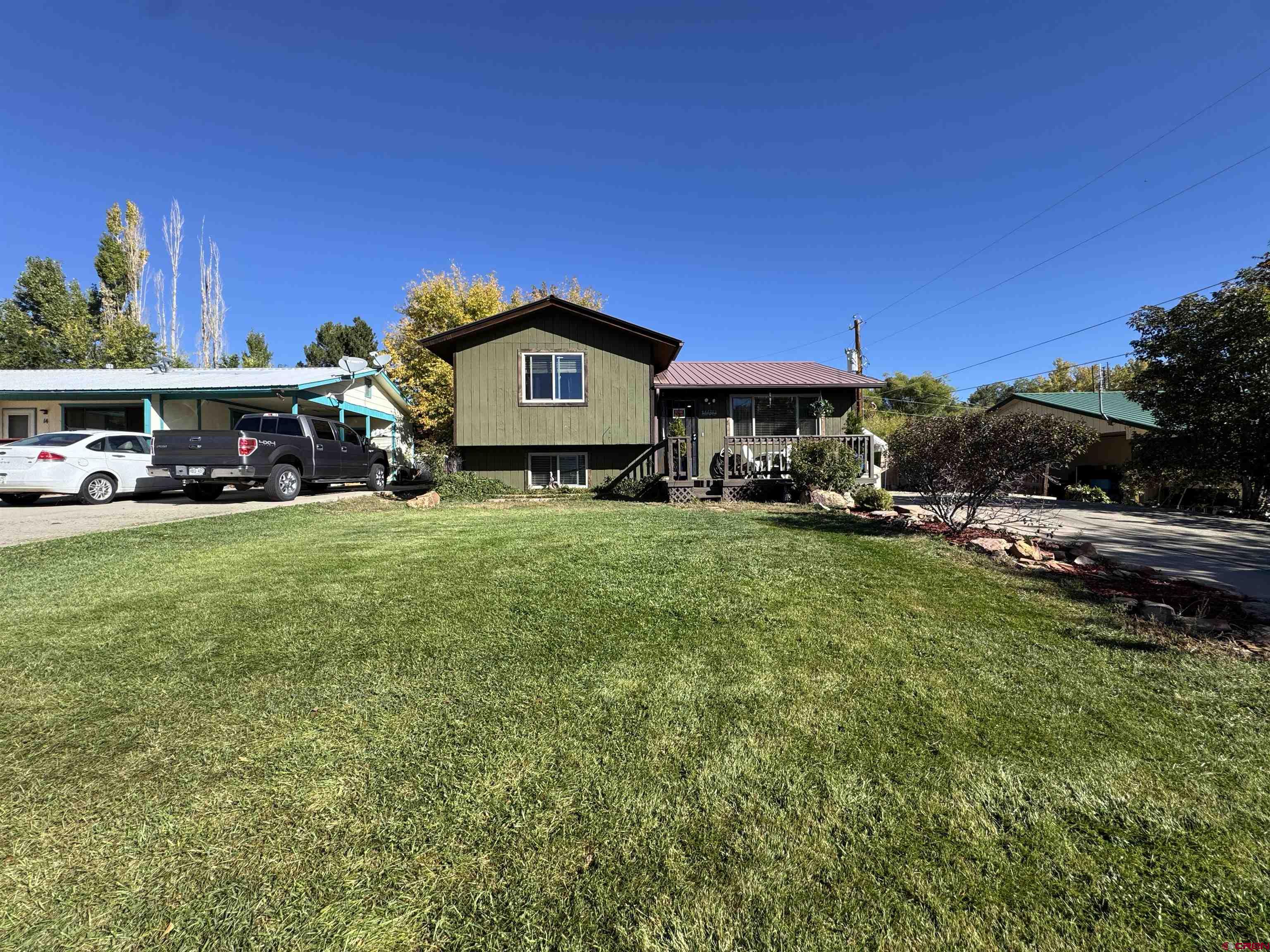 8 West 10th Street Cortez, CO 81321 - Photo 3 of 24 a view of a cars park in front of the house