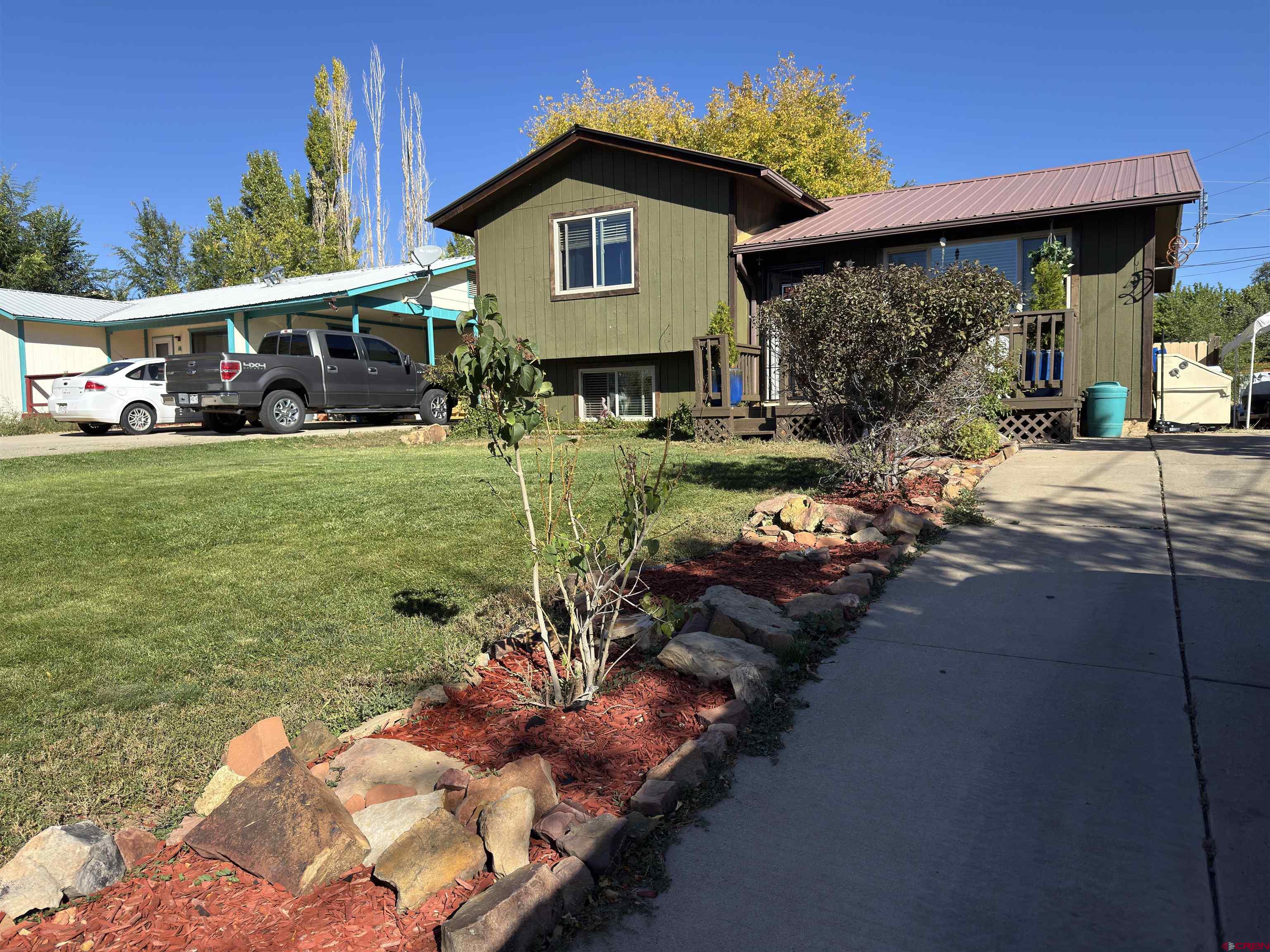 8 West 10th Street Cortez, CO 81321 - Photo 3 of 24 a front view of a house with garden