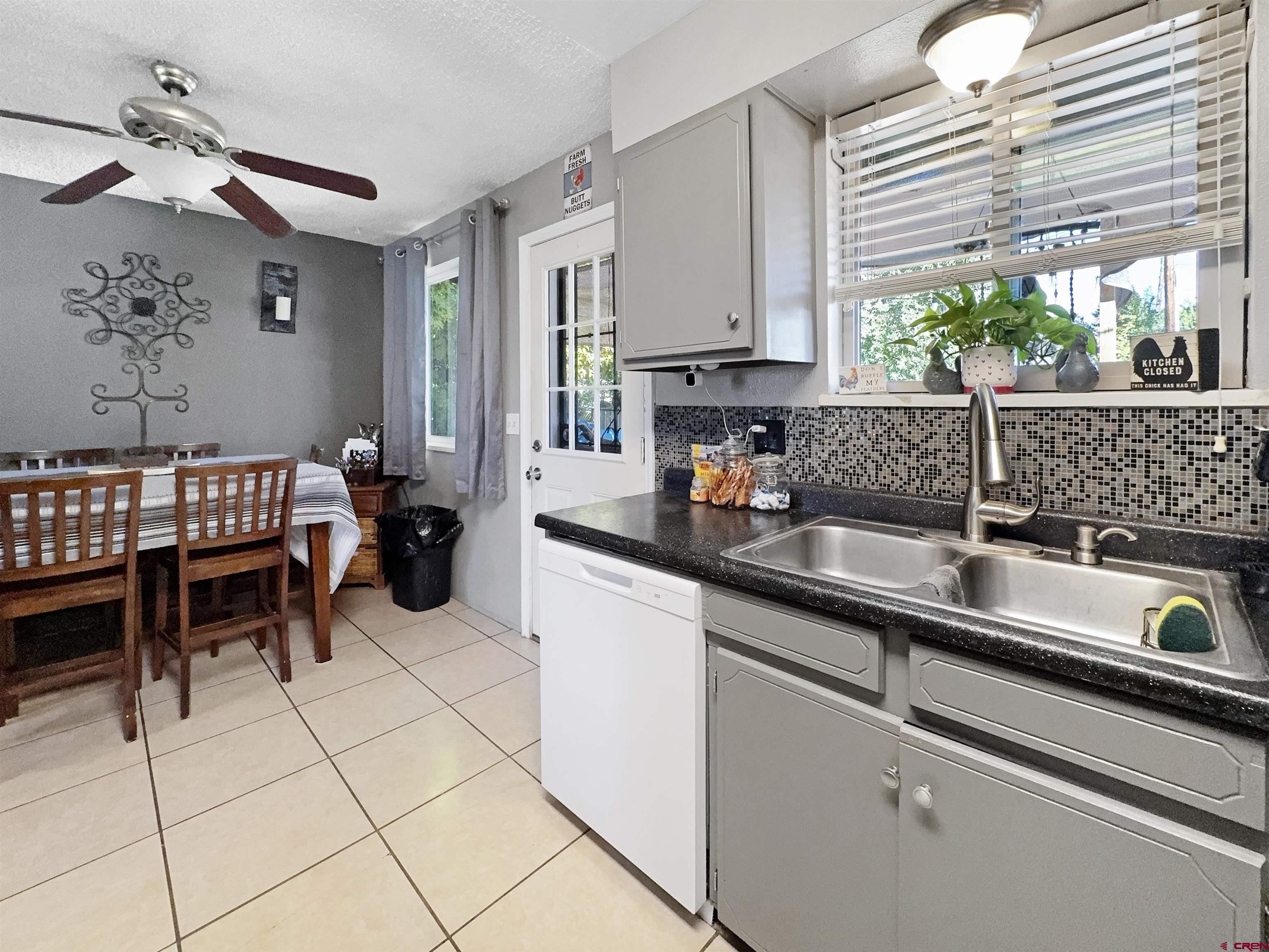 8 West 10th Street Cortez, CO 81321 - Photo 7 of 24 a kitchen with stainless steel appliances granite countertop a sink and cabinets
