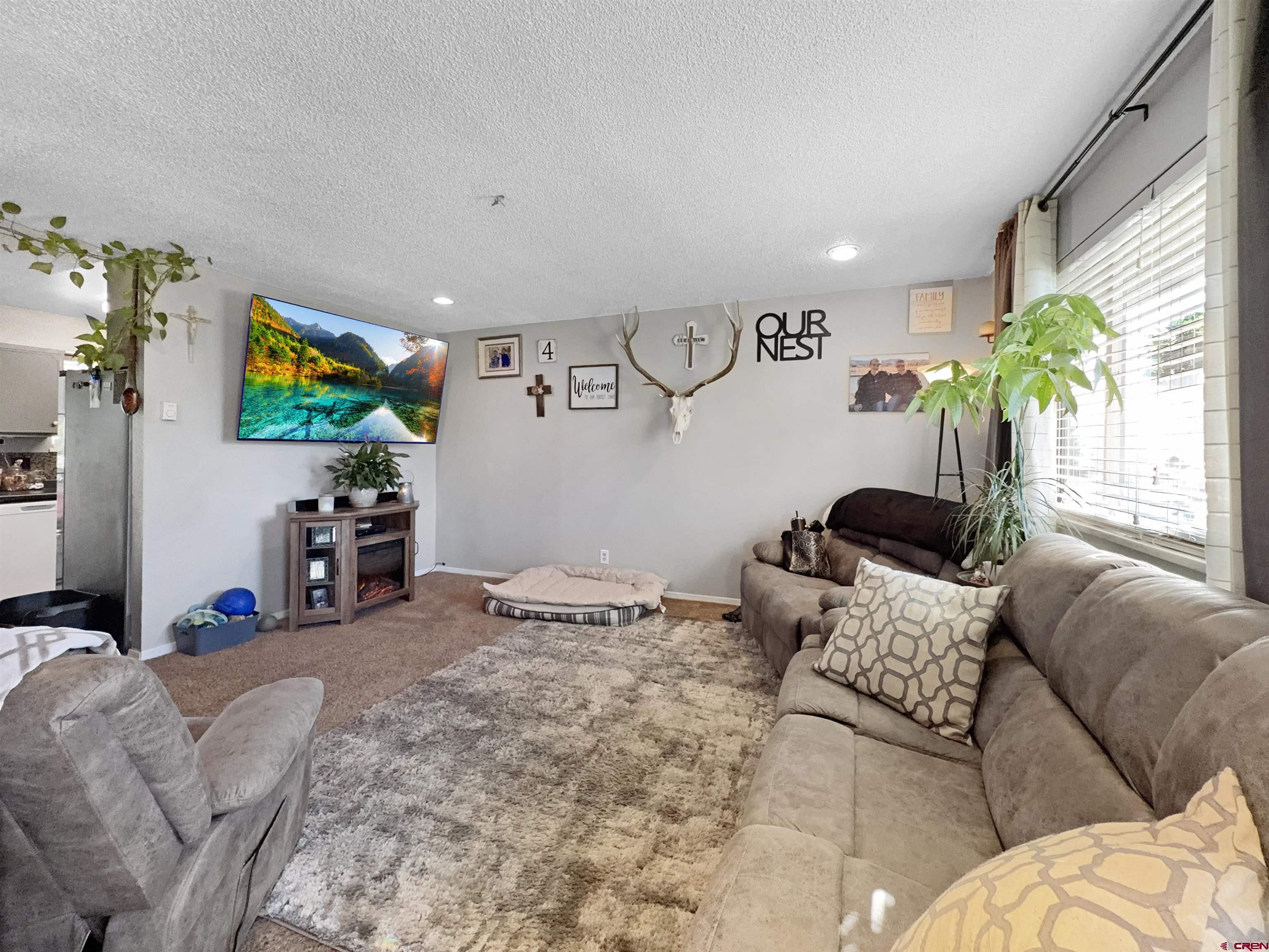 8 West 10th Street Cortez, CO 81321 - Photo 8 of 24 a bedroom with furniture and a flat screen tv