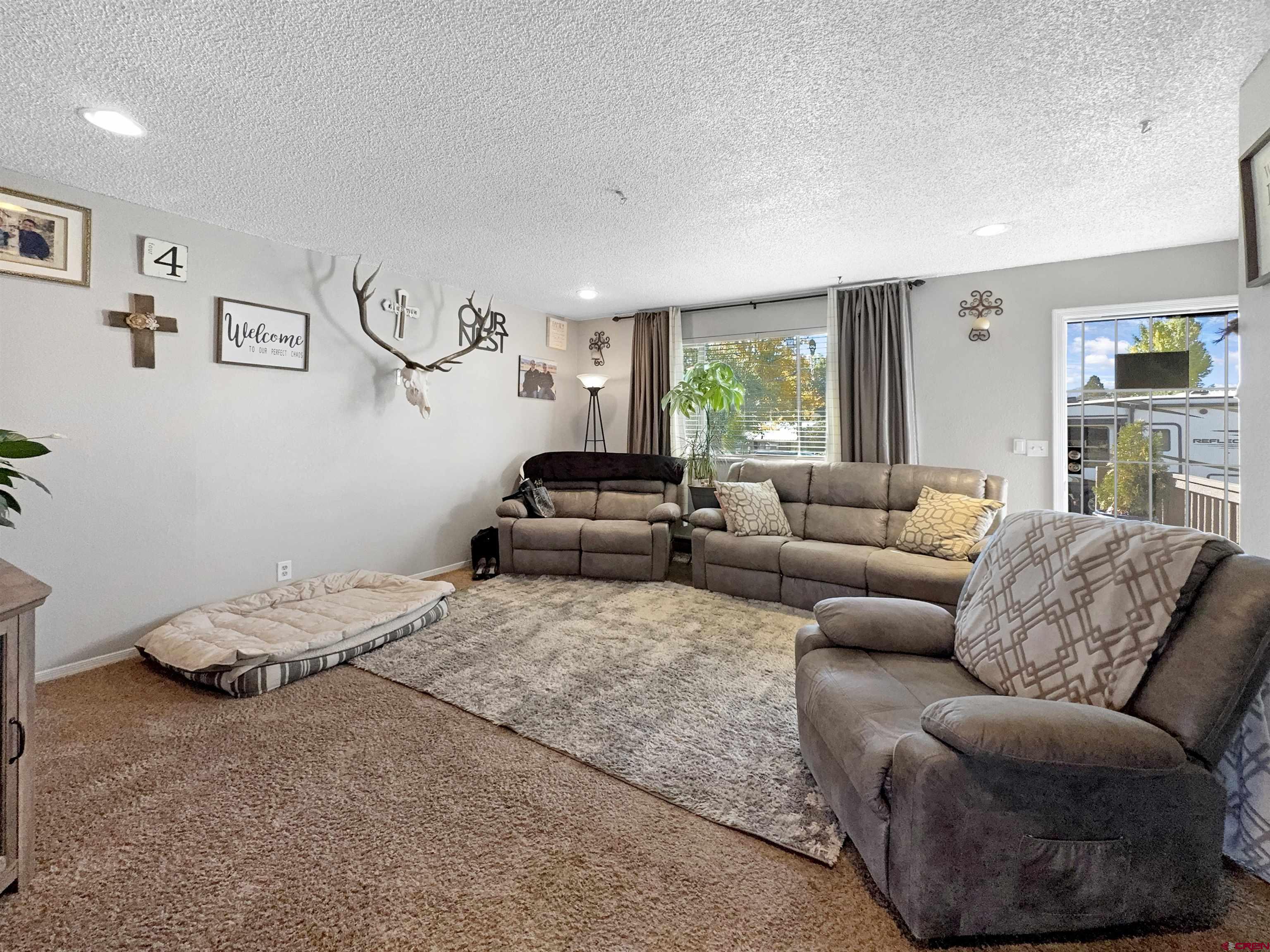 8 West 10th Street Cortez, CO 81321 - Photo 9 of 24 a bedroom with a bed couch and window
