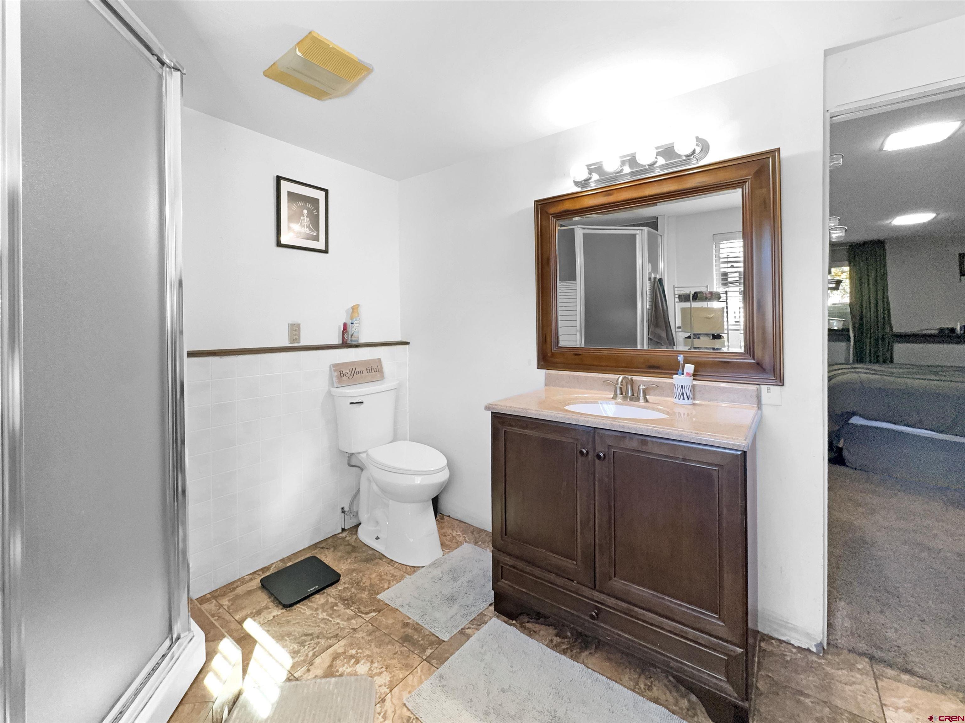 8 West 10th Street Cortez, CO 81321 - Photo 9 of 24 a spacious bathroom with a toilet sink and mirror
