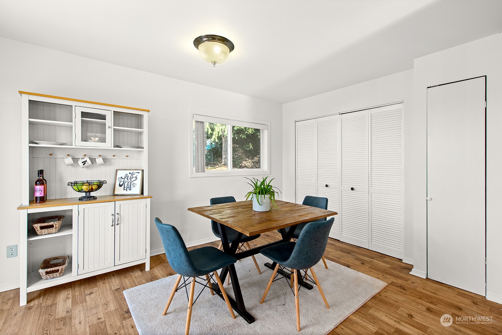 2210 Northeast 8th Street Renton, WA 98056 - Photo 12 of 24 a view of a dining room with furniture and wooden floor
