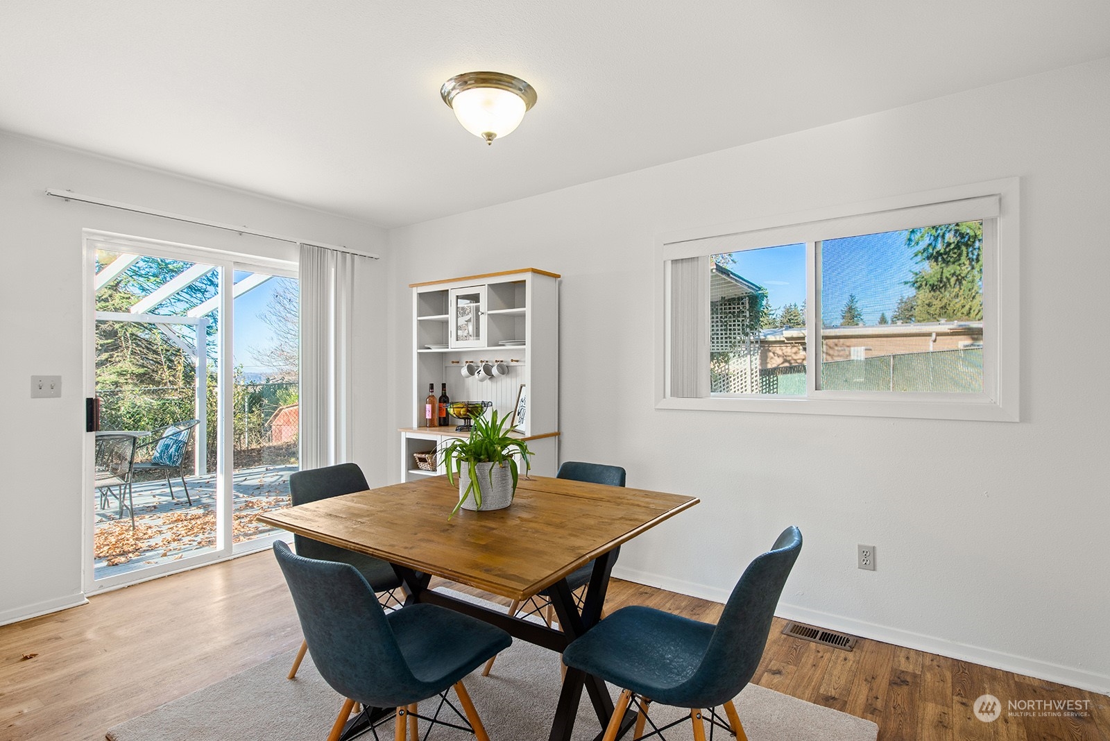 2210 Northeast 8th Street Renton, WA 98056 - Photo 13 of 24 a view of a dining room with furniture window and wooden floor