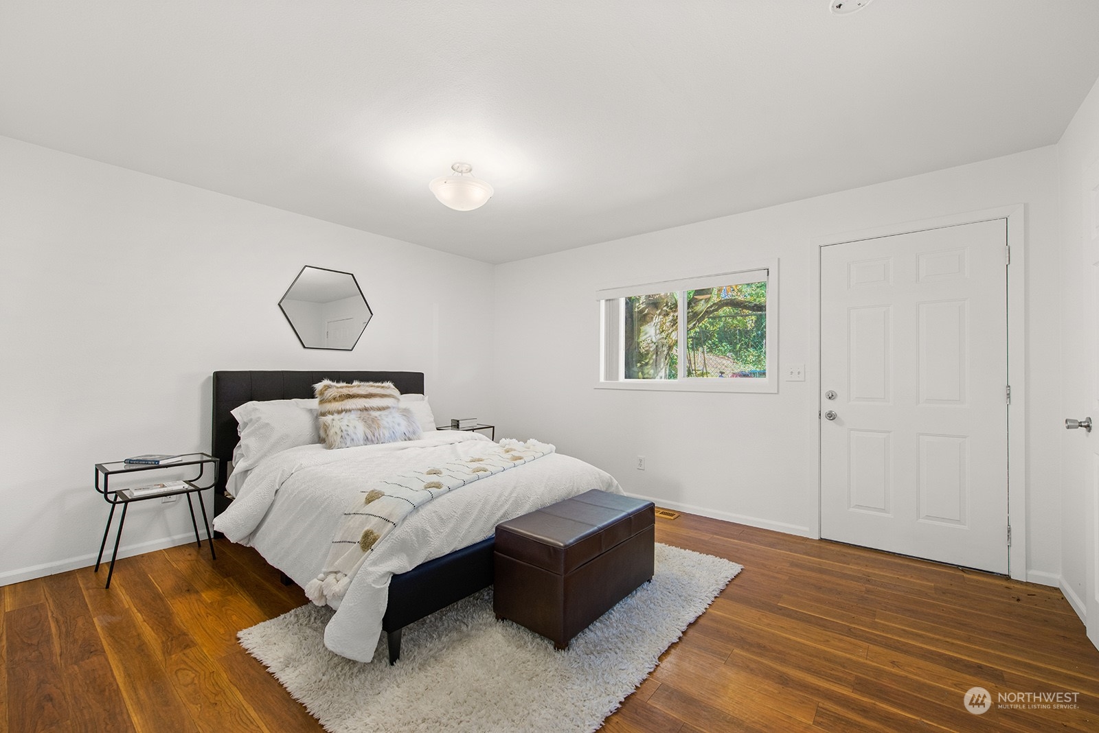2210 Northeast 8th Street Renton, WA 98056 - Photo 14 of 24 a bedroom with a bed lamp and wooden floor