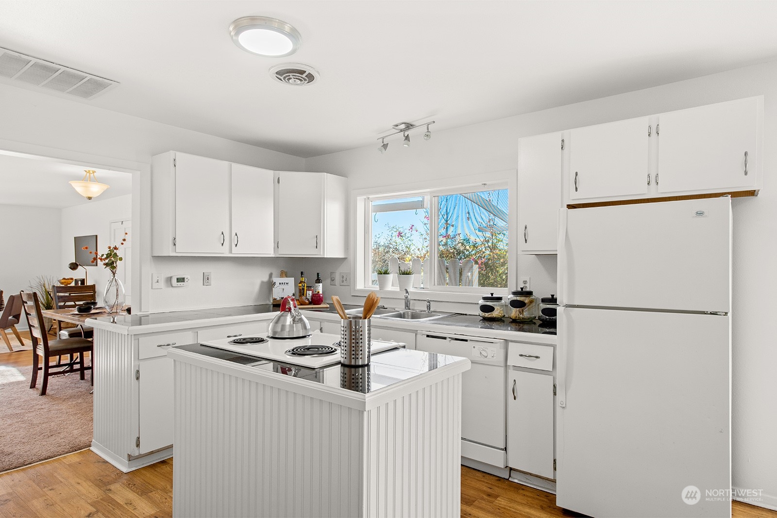 2210 Northeast 8th Street Renton, WA 98056 - Photo 8 of 24 a kitchen with white cabinets and white appliances