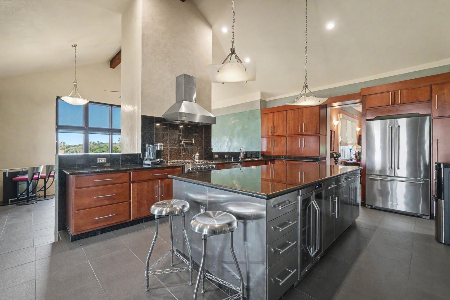 15070 Willow Creek Road Ione, CA 95640 - Photo 32 of 66 a kitchen with stainless steel appliances granite countertop a stove a sink and a refrigerator