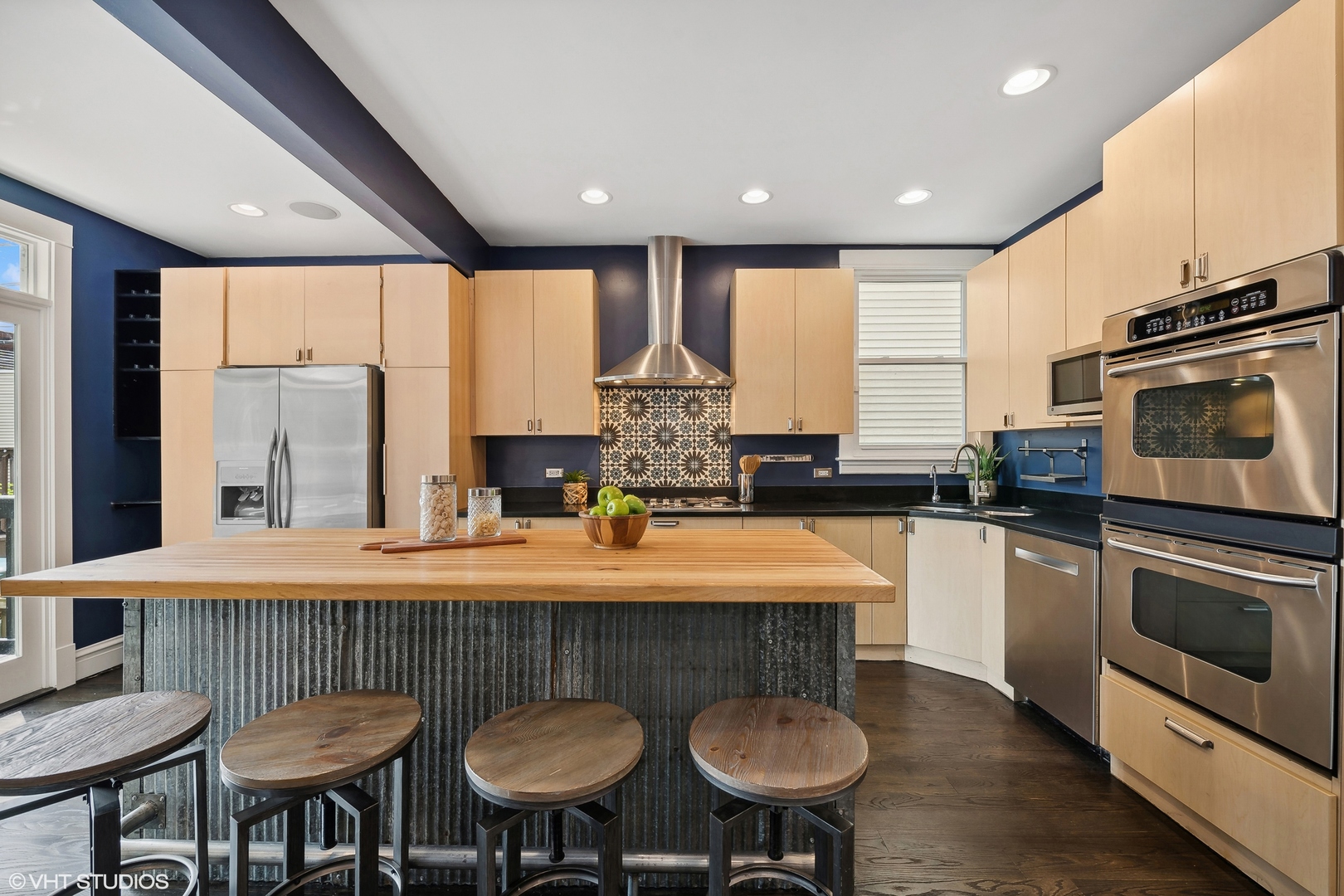 4159 North Bell Avenue Chicago, IL 60618 - Photo 13 of 42 a kitchen with stainless steel appliances granite countertop a kitchen island hardwood floor sink stove dining table and chairs