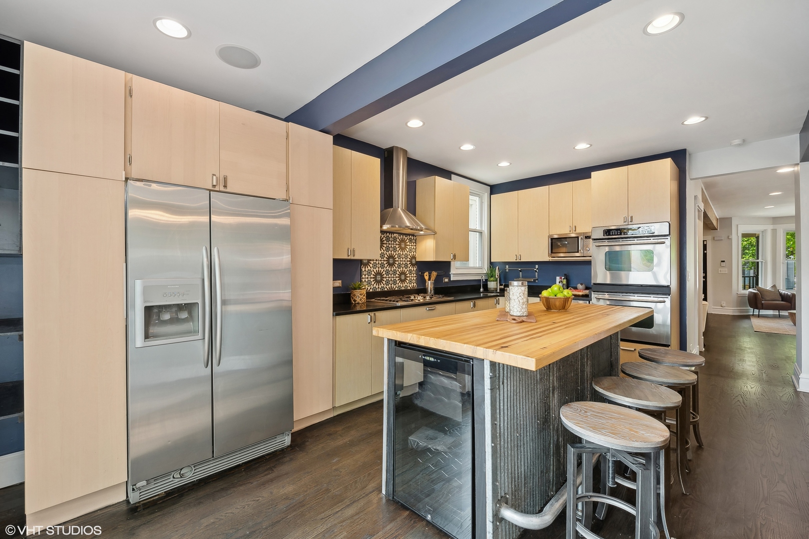 4159 North Bell Avenue Chicago, IL 60618 - Photo 14 of 42 a kitchen with stainless steel appliances granite countertop a table chairs and a refrigerator