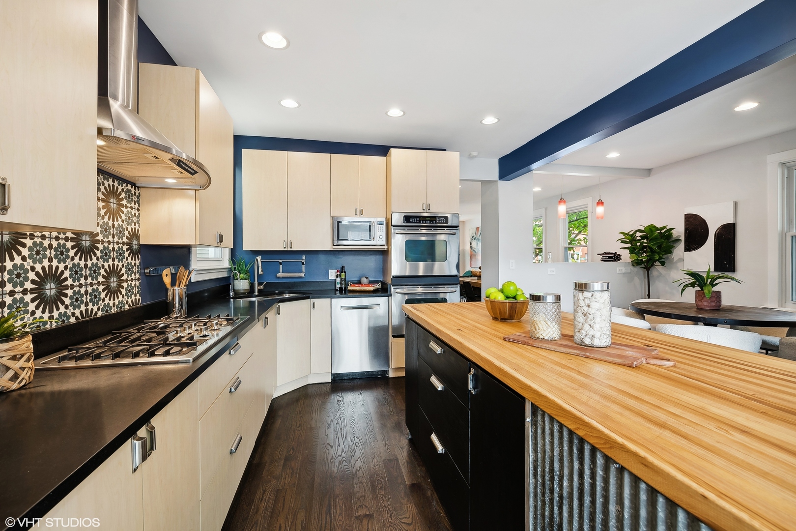 4159 North Bell Avenue Chicago, IL 60618 - Photo 15 of 42 a kitchen with kitchen island granite countertop a sink counter top space and stainless steel appliances