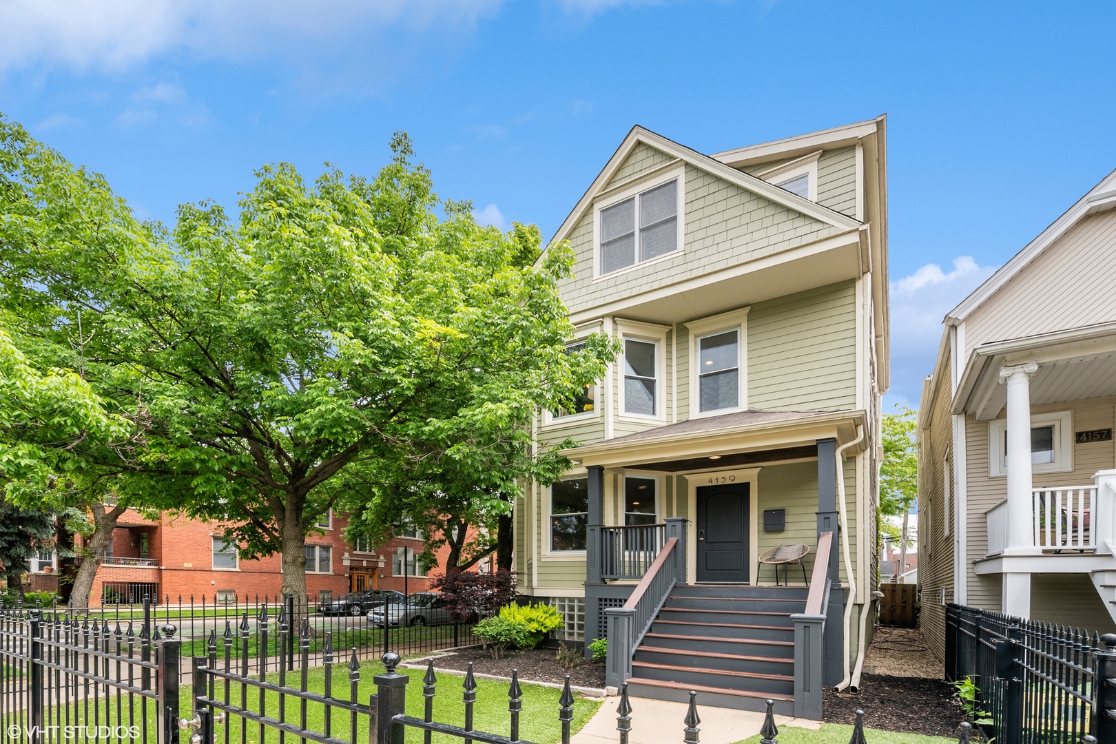 4159 North Bell Avenue Chicago, IL 60618 - Photo 2 of 42 a front view of a house with a garden