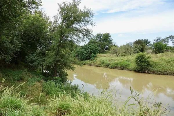 a view of a lake with a yard