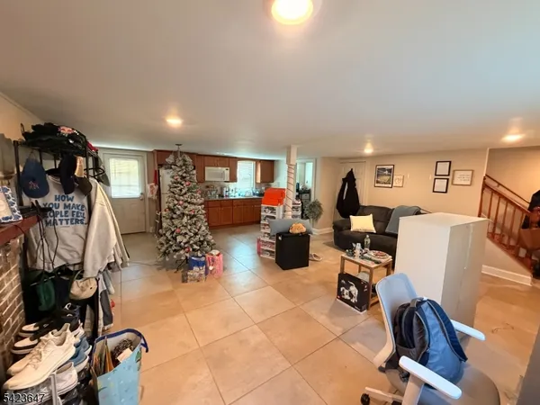 a living room with furniture a air conditioner vent and a window
