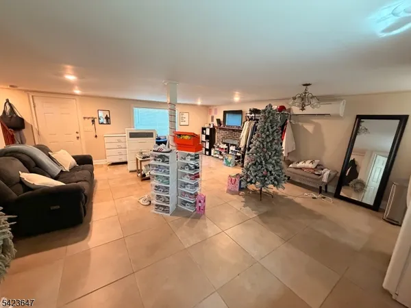 a view of a livingroom with furniture and gym equipment
