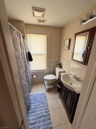 a bathroom with a sink a toilet and a window