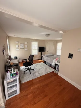 a living room with furniture a rug and a window