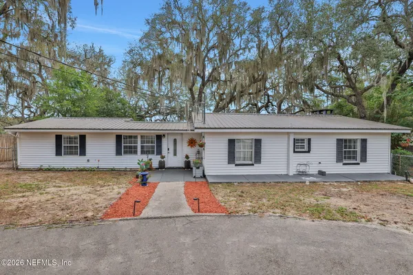 a front view of a house with parking area