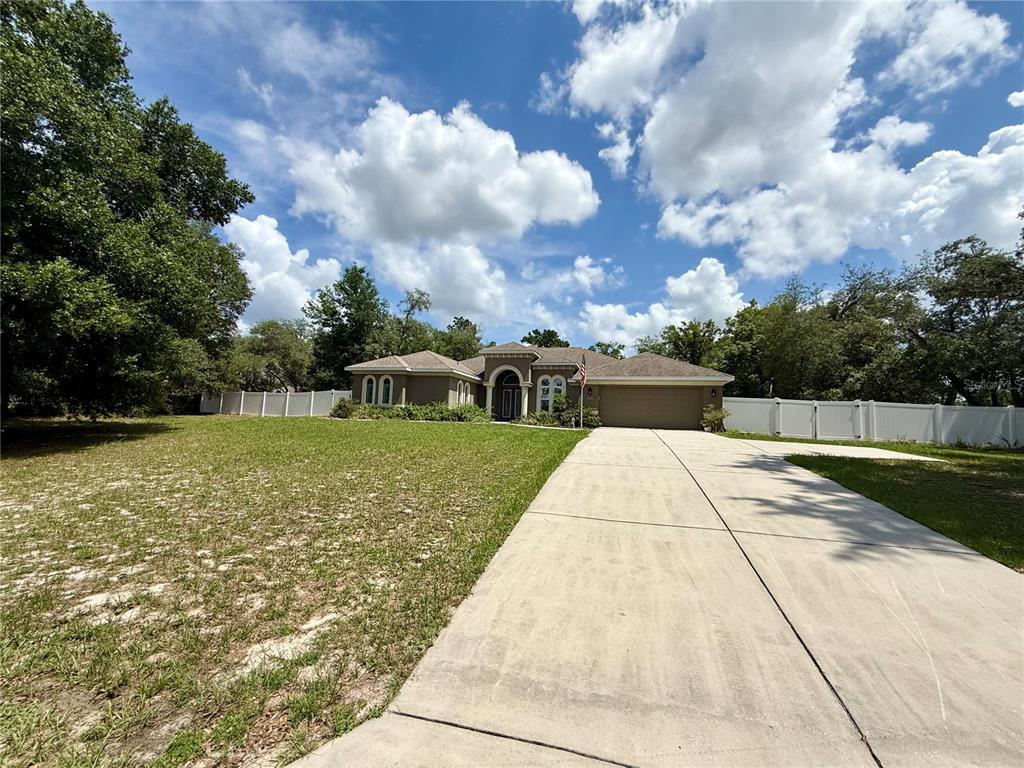 13110 Bamboo Street Spring Hill, FL 34609 - Photo 2 of 56 a view of a garden with a fountain