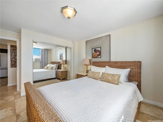 a bedroom with a bed and a large mirror