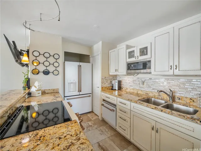 a kitchen with stainless steel appliances granite countertop a sink stove and refrigerator