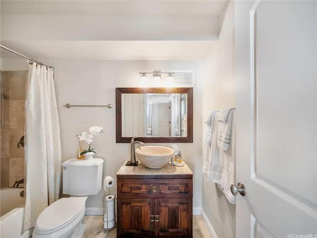 a bathroom with a sink vanity mirror and toilet