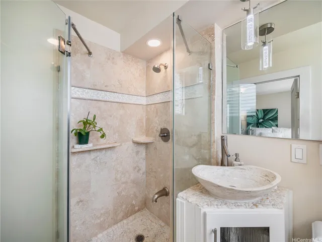 a bathroom with a granite countertop shower sink and mirror