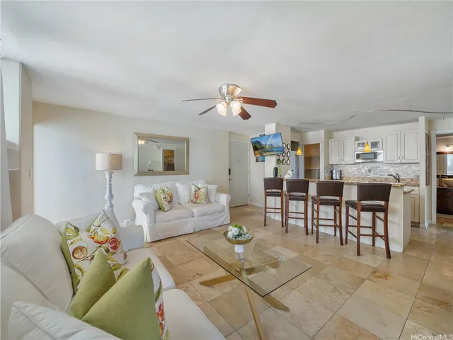 a living room with furniture and kitchen view
