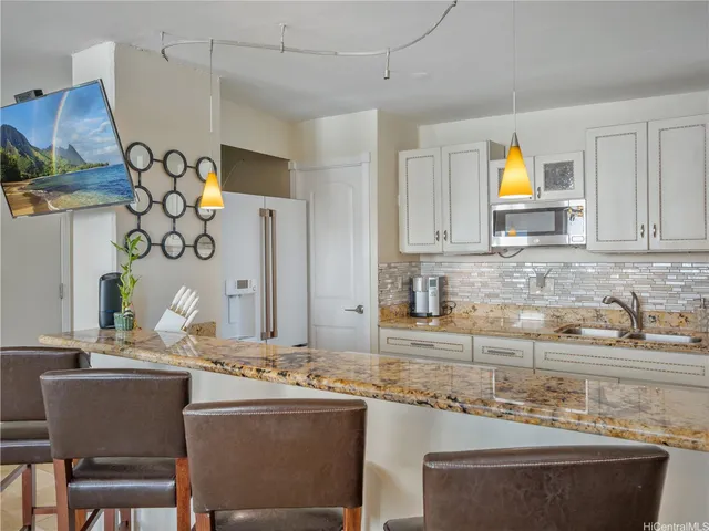 a view of balcony with a couple of cars parked in garage