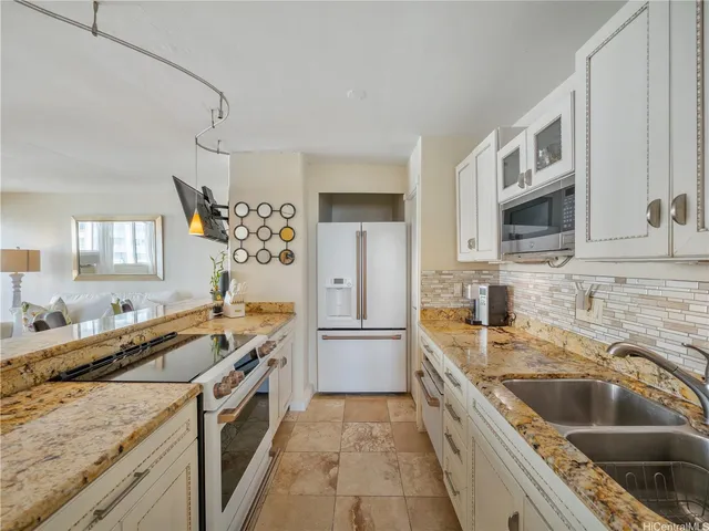 a kitchen that has a sink a stove and refrigerator
