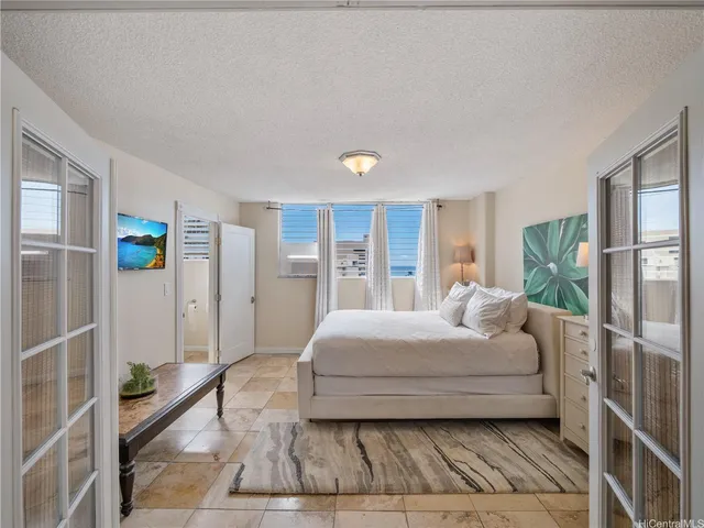 a bedroom with a bed and a window