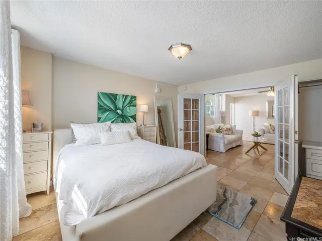 a spacious bedroom with a bed and a couch