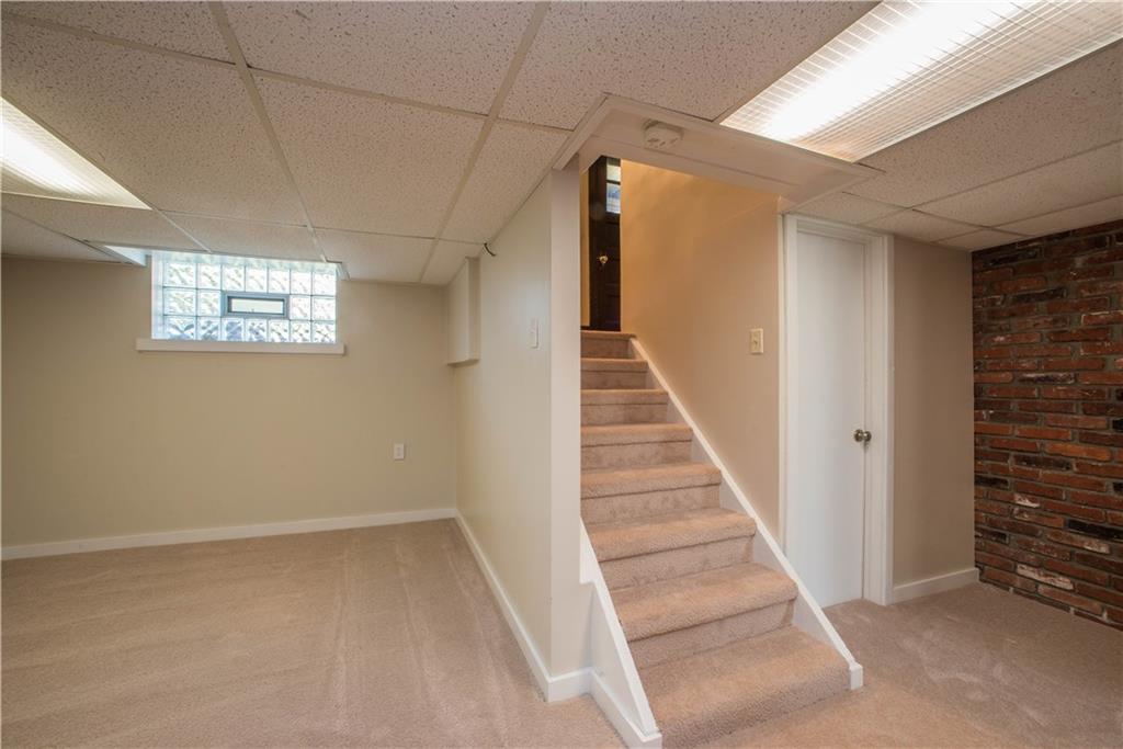 172 Bellbridge Road Elizabeth, PA 15037 - Photo 18 of 25 The finished game room on the lower level is fully carpeted and is accessed from the hallway off the foyer. The door on the right opens to an unfinished room with newer boiler and water heater. Like that found throughout the home, the carpeting here is all new.