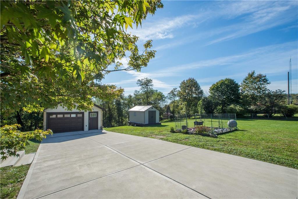 172 Bellbridge Road Elizabeth, PA 15037 - Photo 22 of 25 The view into the right side yard as seen from the driveway. The storage shed at the center remains with the sale. The entire property measures over an acre, so there is ample space available for gardening, entertaining, and play.