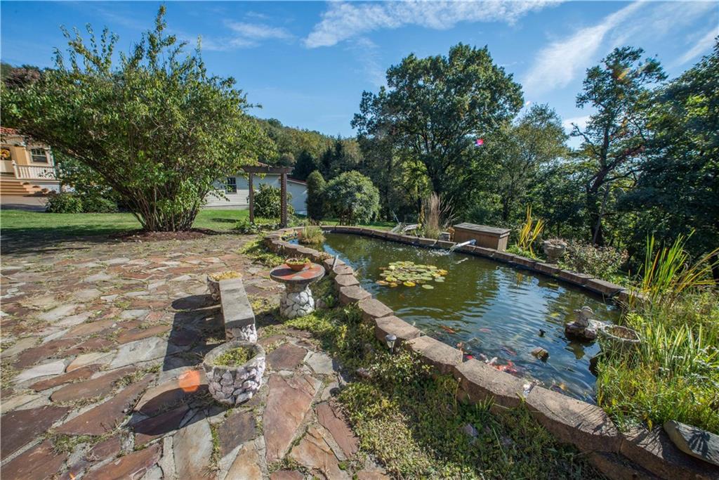 172 Bellbridge Road Elizabeth, PA 15037 - Photo 24 of 25 A flagstone patio leads to the koi pond. Please don't feed the fish! When night temperatures fall below 60 degrees F, the fish survive on algae growing inside the pond instead of supplemental food.
