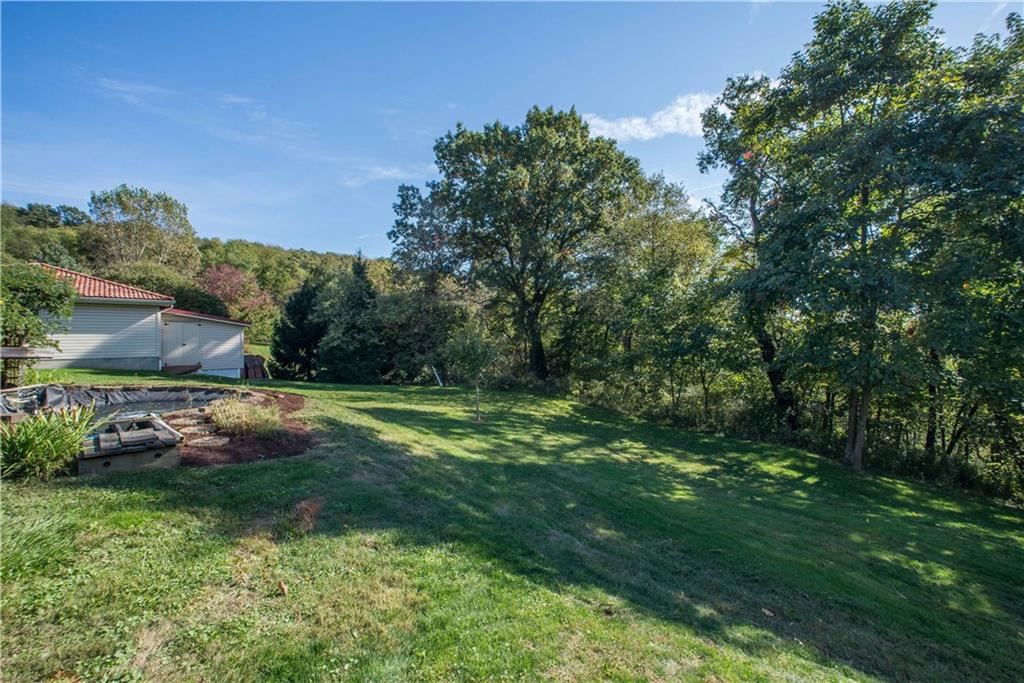 172 Bellbridge Road Elizabeth, PA 15037 - Photo 25 of 25 There is still more yard behind the detached garage, which is shown here. There is a natural border of mature trees between properties. The header pond for the koi pond is found here as well. A home warranty is also offered.