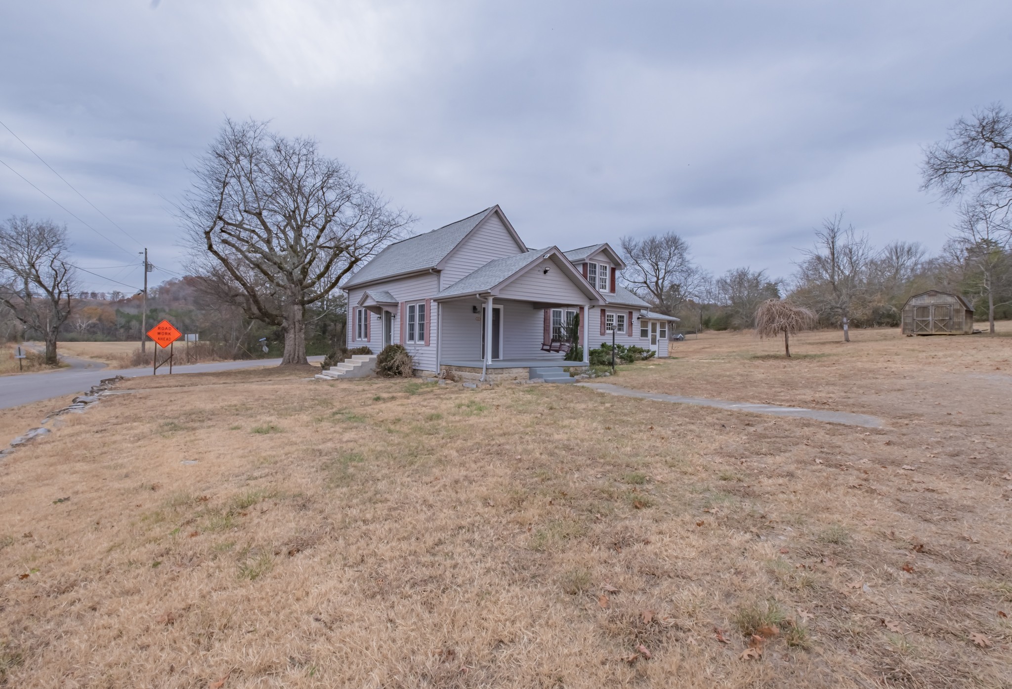 1322 Marble Hill Road Winchester, TN 37398 - Photo 28 of 32 a backyard of a house with wooden fence and large trees
