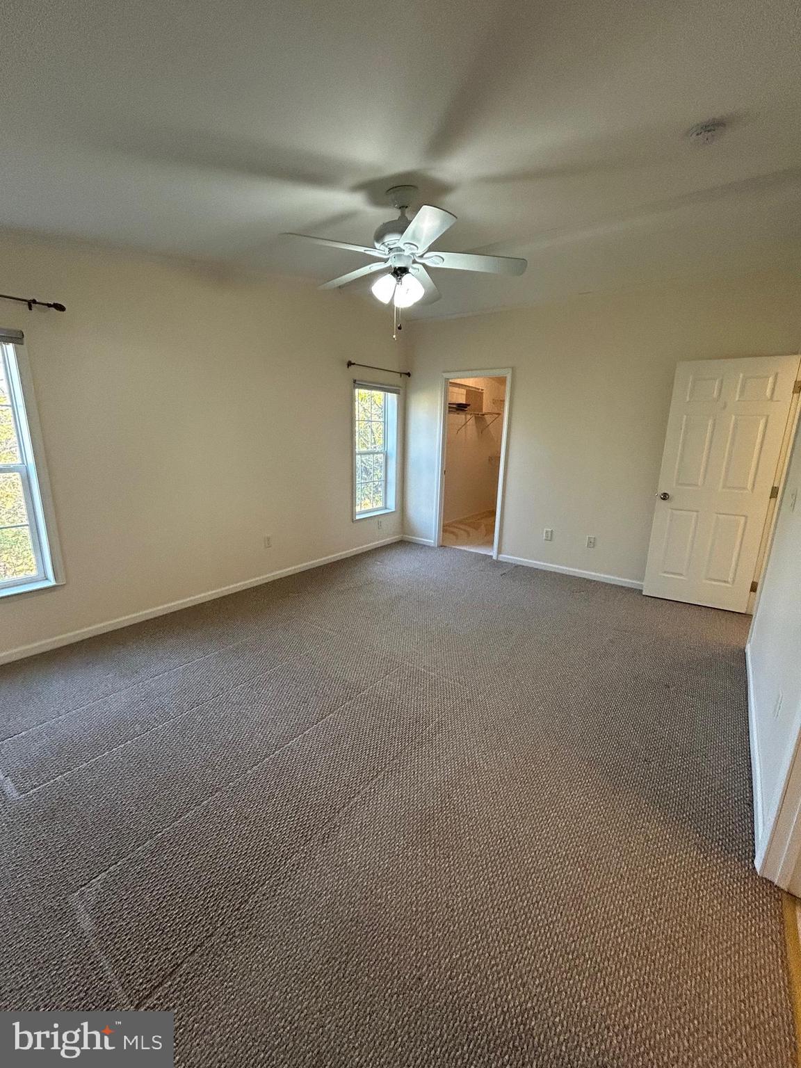 94 Random Road Douglassville, PA 19518 - Photo 17 of 27 an empty room with chandelier fan and windows