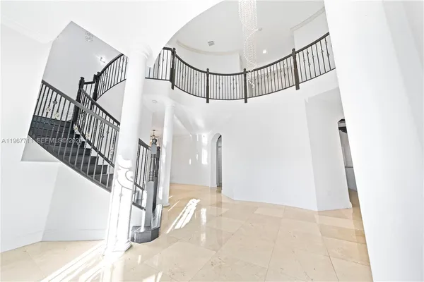 a view of walk in closet with window and white walls
