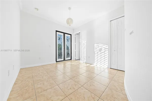 a view of a hallway with wooden floor and a small white door