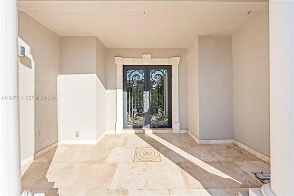 a view of a bedroom with a bed and a window