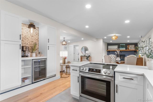 a kitchen with stove cabinets and wooden floor