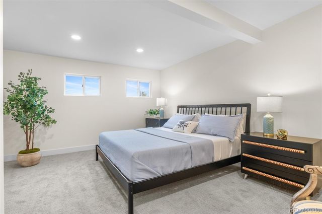 a bedroom with a bed and a potted plant