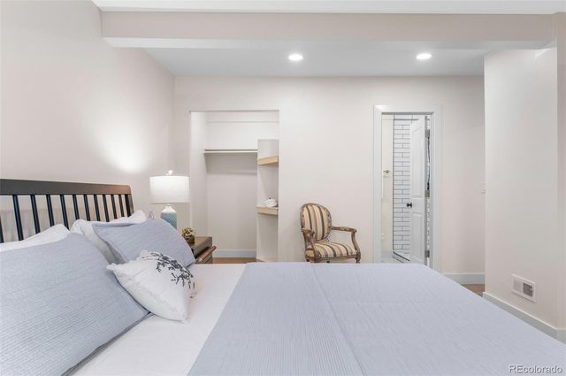 a bedroom with a bed and a lamp