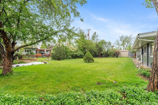 a yellow house with swimming pool in front of it
