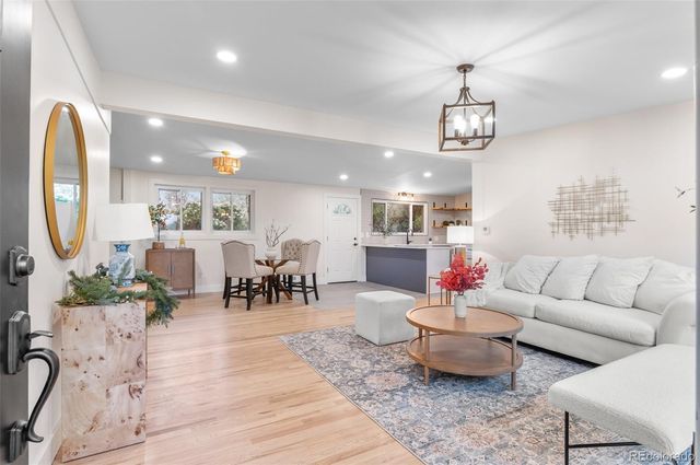 a living room with furniture kitchen view and a dining table